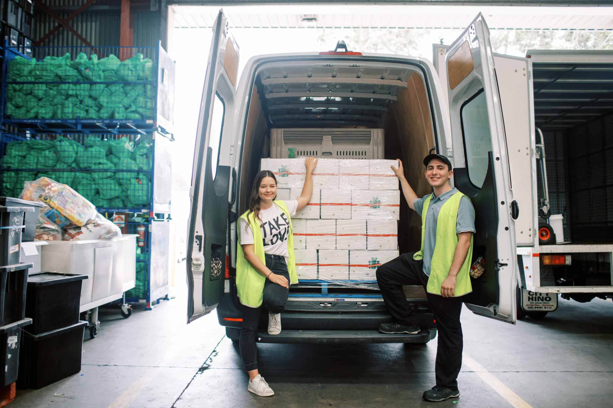 Driver's packing boxes in a van